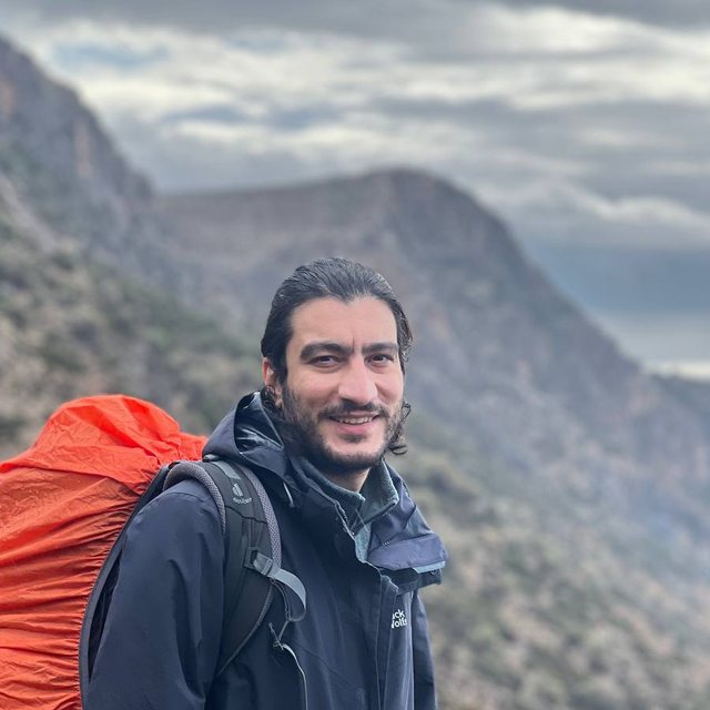 Portrait of Pejman Shojaee outdoors in the mountains